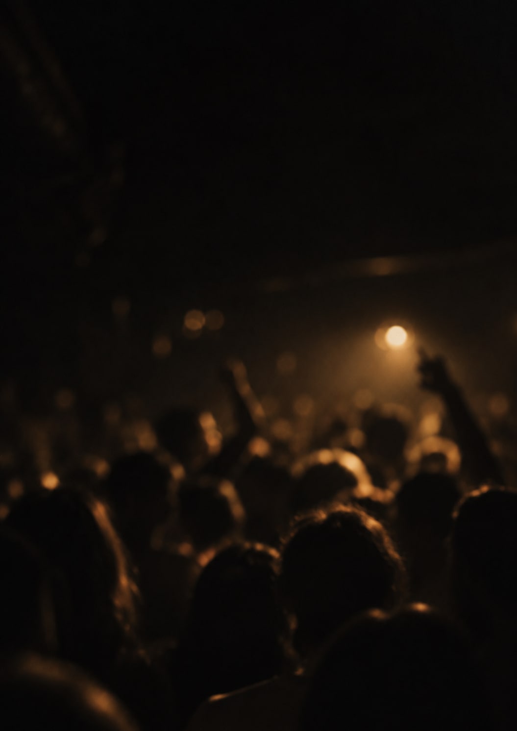 Softly blurred dancefloor silhouettes in muted gold light, artwork from Beyond the Mix